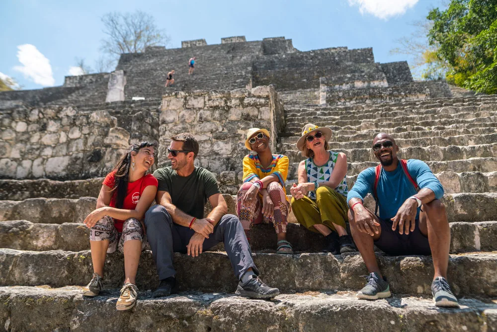 Travellers resting on ancient stone steps during a guided Teotihuacan pyramids tour from Mexico City