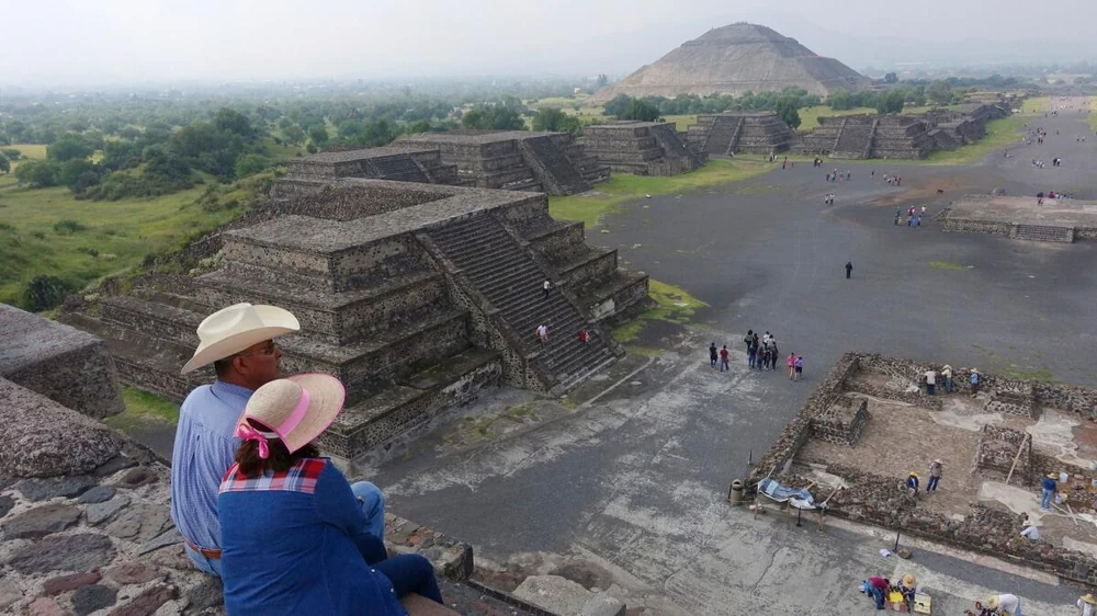 Visitors looking out over the Teotihuacan archaeological zone toward the Pyramid of the Sun on a guided pyramids tour